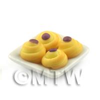 Miniature Purple Iced Spiral Buns On A Square Plate