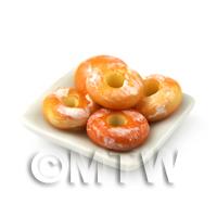 Miniature White Glazed Ring Donuts On A Square Plate