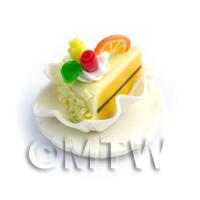 Miniature Pale Yellow Iced Individual Cake Slice On A Clay Plate