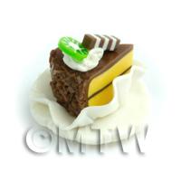 Miniature Chocolate Covered Individual Cake Slice On A Clay Plate