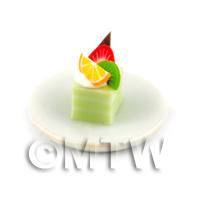 Miniature Green  And White Square Cake Slice Topped With Fruit