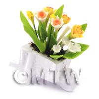 Mixed White and Yellow Flowers in a Miniature Wheelbarrow Planter