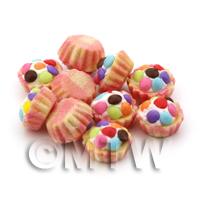 Miniature Smartie Topped Cupcake With Pink And Yellow Paper Cup