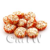 Miniature Chopped Almond Cupcake With A Orange And White Paper Cup