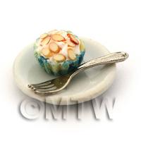 Miniature Chopped Almond Cupcake In A Blue Paper Cup On A Plate With A Fork