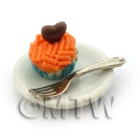 Miniature Orange Sprinkle Cupcake In A Blue Paper Cup On A Plate With A Fork
