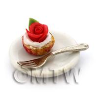Miniature Red Rose Cupcake In An Orange Paper Cup On A Plate With A Fork