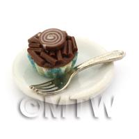 Miniature Chocolate Sprinkle Cupcake In A Blue Paper Cup On A Plate With A Fork