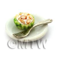Miniature Chopped Almond Cupcake In A Green Cup On A Plate With A Fork