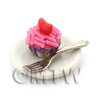 Miniature Pink Sprinkle Cupcake In A Violet Paper Cup On A Plate With A Fork
