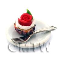 Miniature Red Rose Cupcake In A Violet Paper Cup On A Plate With A Fork