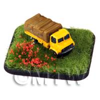 yellow painted light lorry on a grass style base