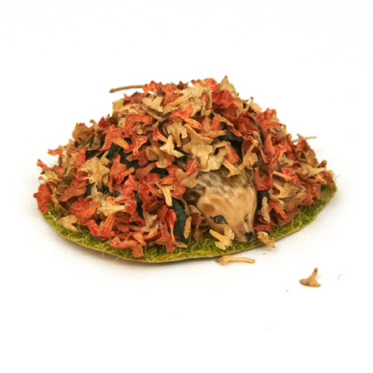 Peek-a-boo! Ceramic hedgehog hiding in a pile of leaves